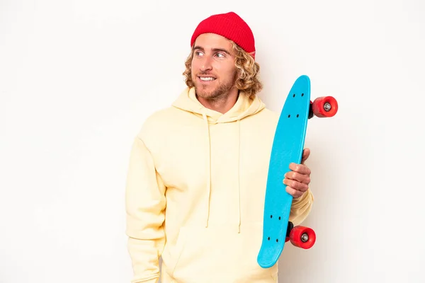 Young Skater Caucasian Man Isolated White Background Looks Aside Smiling — Stok fotoğraf