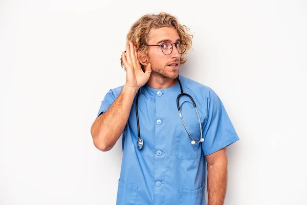 Young Nurse Caucasian Man Isolated White Background Trying Listening Gossip — Stockfoto