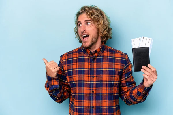 Young Caucasian Man Holding Passport Isolated Blue Background Points Thumb — ストック写真