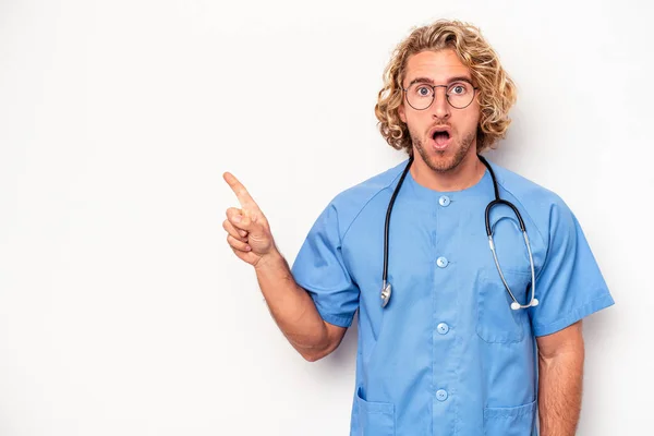 Young Nurse Caucasian Man Isolated White Background Pointing Side — Stock Photo, Image