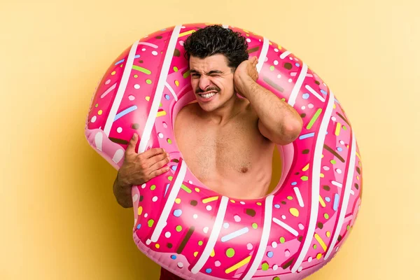 Young Caucasian Man Holding Inflatable Donut Isolated Yellow Background Covering — Stock Fotó
