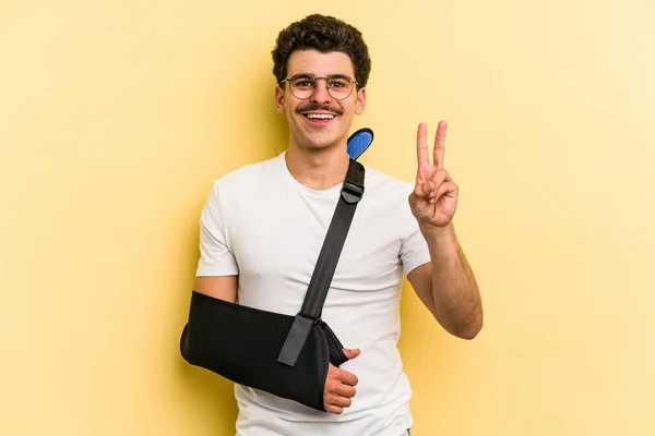 Young Caucasian Man Broke Hand Isolated Yellow Background Joyful Carefree — Foto Stock
