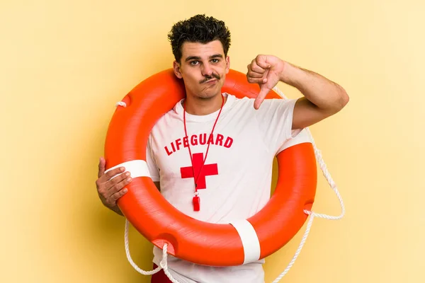 Young Caucasian Lifeguard Man Isolated Yellow Background Showing Dislike Gesture — 图库照片