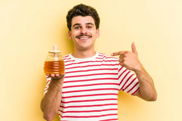 Young Caucasian Man Holding Honey Jar Isolated Yellow Background Person — ストック写真