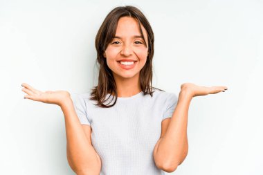 Genç İspanyol kadın mavi arka planda izole edilmiş zafer sonrası yumruğunu kaldırıyor, kazanan konsept..