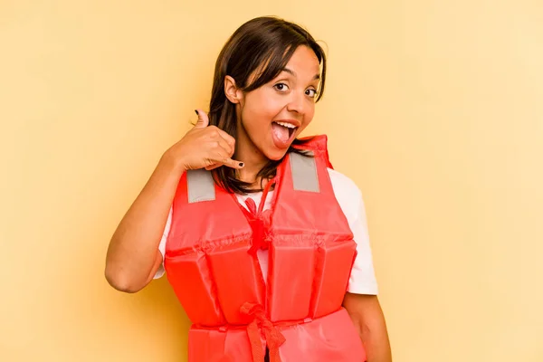 Young Hispanic Woman Holding Life Jacket Isolated Yellow Background Showing — Stock Photo, Image
