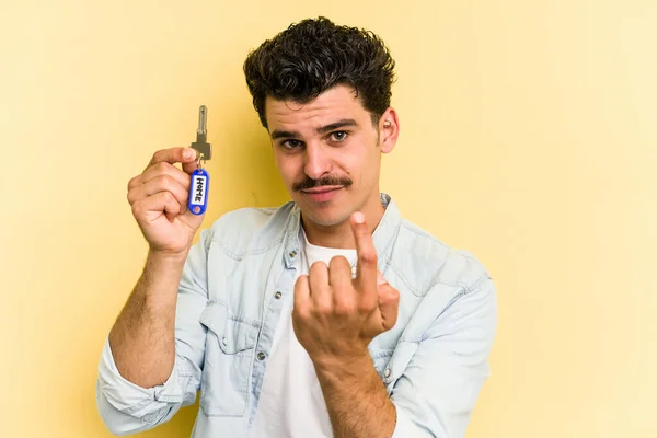 Young Caucasian Man Holding Home Keys Isolated Yellow Background Pointing — Stock Fotó