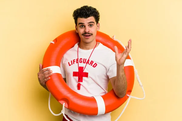 Young Caucasian Lifeguard Man Isolated Yellow Background Surprised Shocked — 图库照片