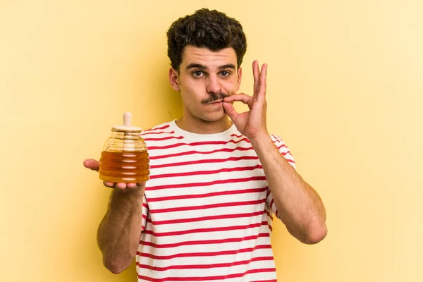 Young Caucasian Man Holding Honey Jar Isolated Yellow Background Fingers — Fotografia de Stock