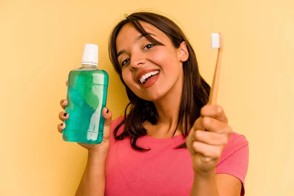 Young Hispanic Woman Holding Mouthwash Isolated Yellow Background — Stockfoto