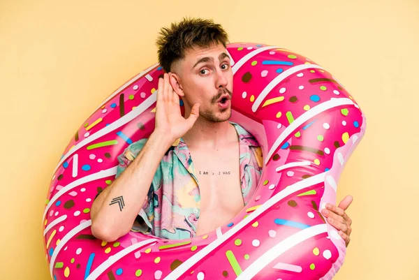 Young Caucasian Man Holding Inflatable Donut Isolated Yellow Background Trying — 图库照片