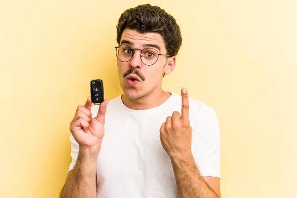 Young Caucasian Man Holding Car Keys Isolated Yellow Background Having — Photo