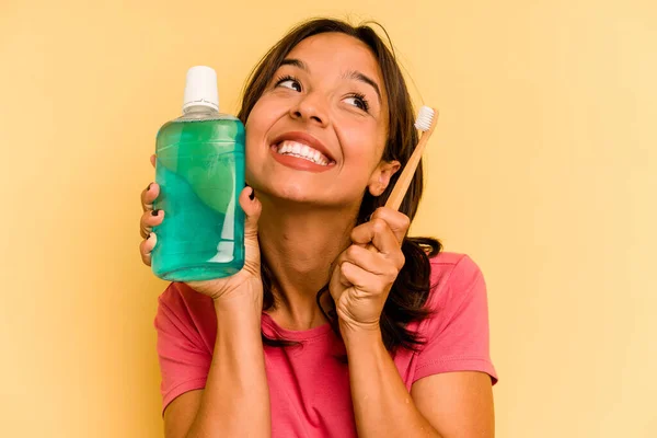 Young Hispanic Woman Holding Mouthwash Isolated Yellow Background —  Fotos de Stock