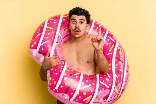 Young Caucasian Man Holding Inflatable Donut Isolated Yellow Background Having — 图库照片