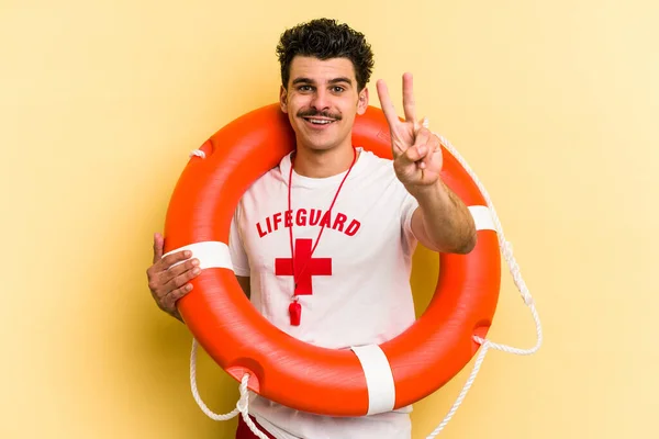 Young Caucasian Lifeguard Man Isolated Yellow Background Showing Number Two — ストック写真