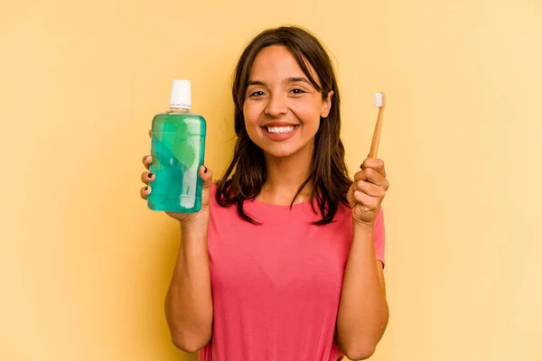 Young Hispanic Woman Holding Mouthwash Isolated Yellow Background — Stockfoto