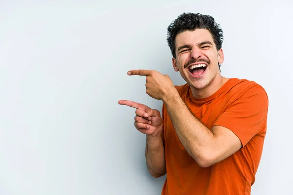 Young Caucasian Man Isolated Blue Background Excited Pointing Forefingers Away — Stock Photo, Image