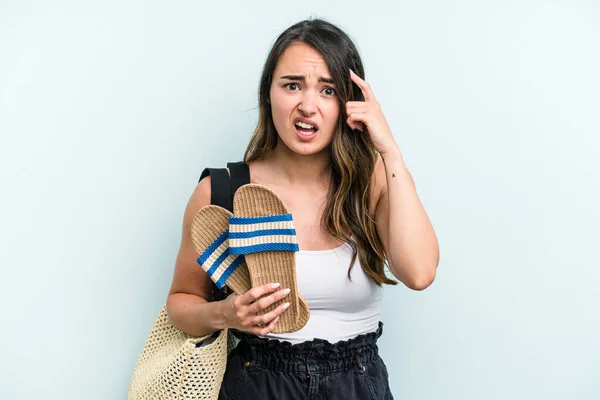 Young Caucasian Woman Holding Sandals Isolated Blue Background Showing Disappointment — Stockfoto