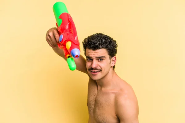 Young Caucasian Man Playing Water Gun Isolated Yellow Background — ストック写真
