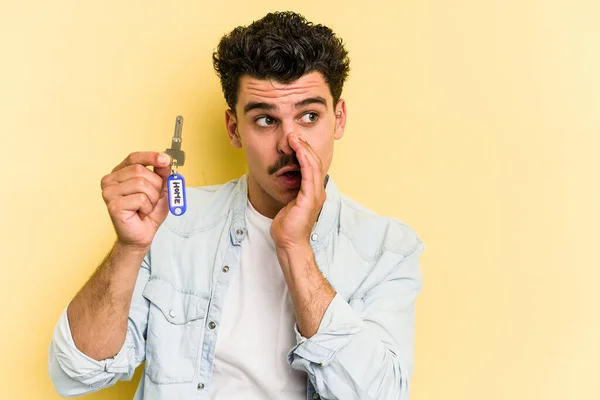 Young Caucasian Man Holding Home Keys Isolated Yellow Background Saying — Stock fotografie