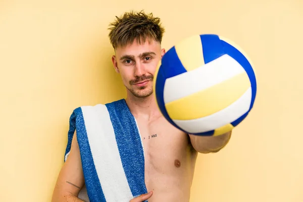 Young Caucasian Man Playing Volleyball Isolated Yellow Background — Stok fotoğraf