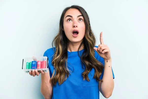 Young Caucasian Woman Holding Batteries Isolated Blue Background Pointing Upside — ストック写真