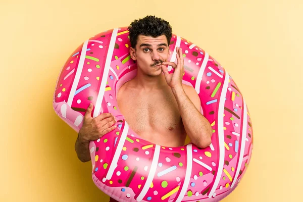 Young Caucasian Man Holding Inflatable Donut Isolated Yellow Background Fingers — Stock fotografie