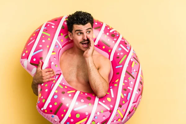 Young Caucasian Man Holding Inflatable Donut Isolated Yellow Background Saying — 图库照片