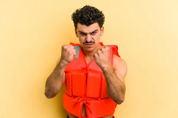 Young Caucasian Man Wearing Life Jacket Isolated Yellow Background Showing — 图库照片