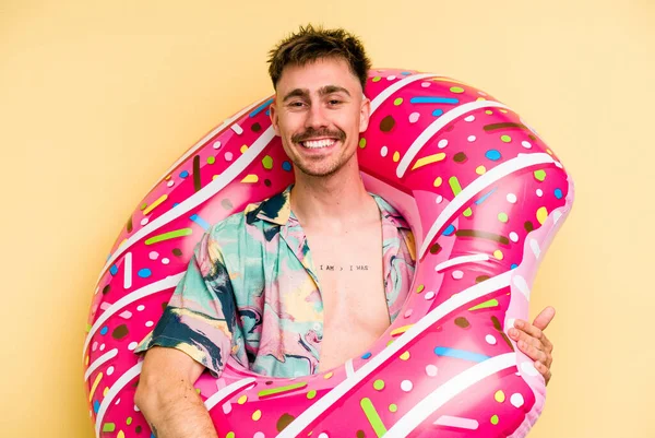 Young Caucasian Man Holding Inflatable Donut Isolated Yellow Background Happy — 图库照片