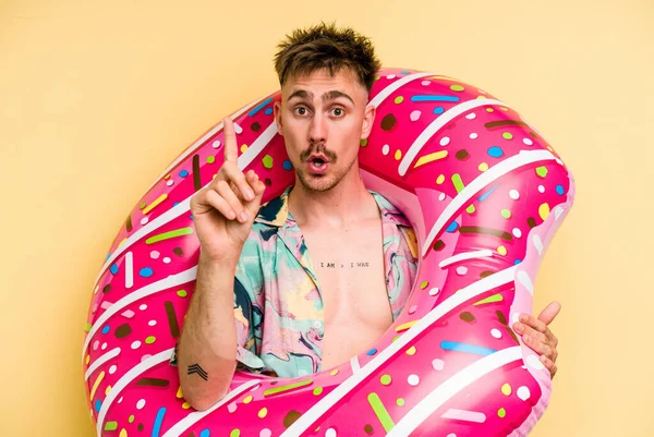Young Caucasian Man Holding Inflatable Donut Isolated Yellow Background Having — 图库照片