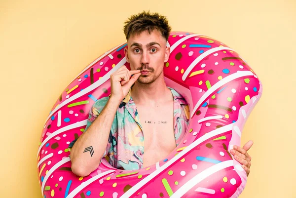 Young Caucasian Man Holding Inflatable Donut Isolated Yellow Background Fingers — 图库照片