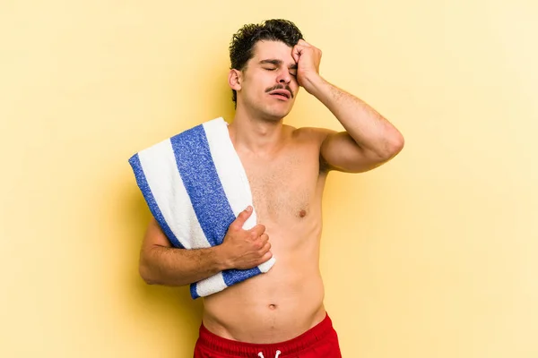 Young Caucasian Man Holding Beach Towel Isolated Yellow Background Being — Photo