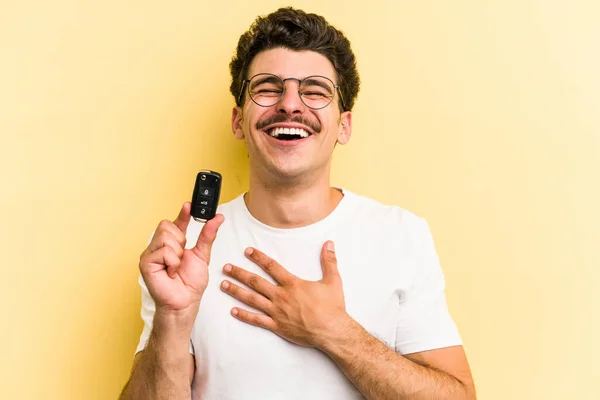 Young Caucasian Man Holding Car Keys Isolated Yellow Background Laughs — Fotografia de Stock