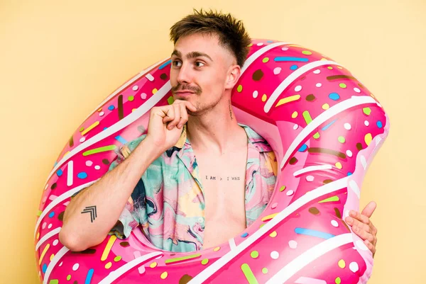 Young Caucasian Man Holding Inflatable Donut Isolated Yellow Background Looking — 图库照片