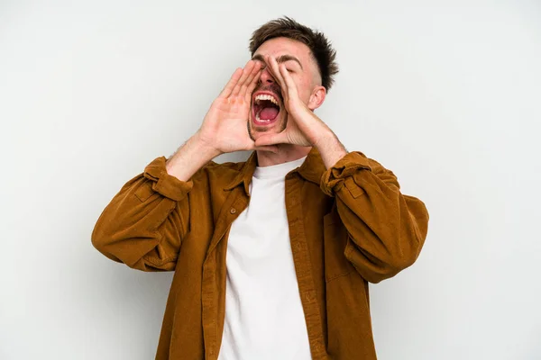 Young caucasian man isolated on white background shouting excited to front.