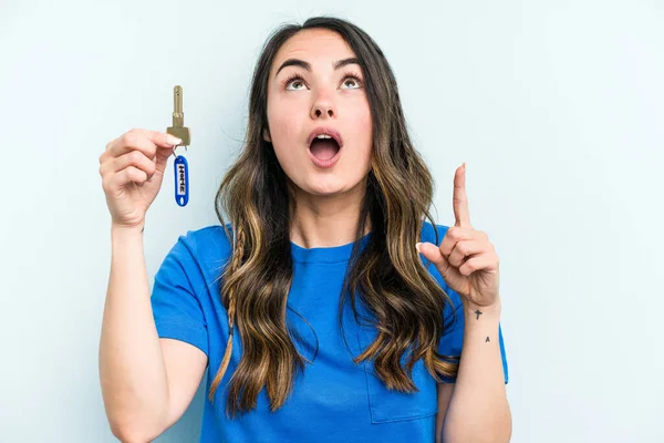 Young Caucasian Woman Holding Home Keys Isolated Blue Background Pointing — Fotografia de Stock