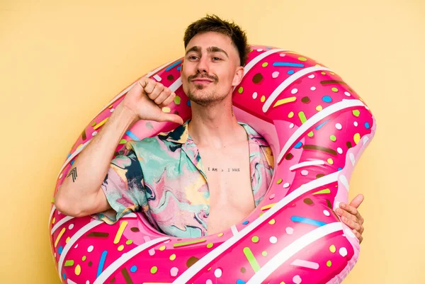 Young Caucasian Man Holding Inflatable Donut Isolated Yellow Background Feels — 图库照片