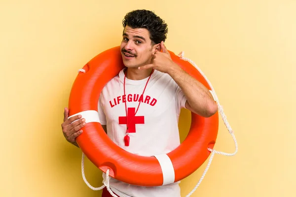 Young Caucasian Lifeguard Man Isolated Yellow Background Showing Mobile Phone — Foto de Stock