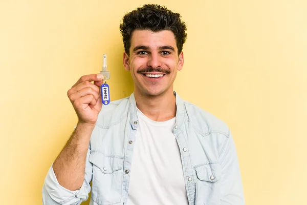 Young Caucasian Man Holding Home Keys Isolated Yellow Background Happy — Stock fotografie