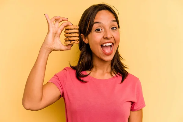 Young Hispanic Woman Holding Cookies Isolated Yellow Background — Stock Fotó