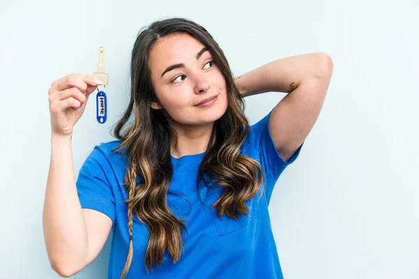 Young Caucasian Woman Holding Home Keys Isolated Blue Background Touching — Stock fotografie