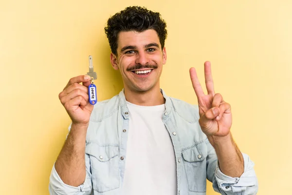 Young Caucasian Man Holding Home Keys Isolated Yellow Background Joyful — Stockfoto