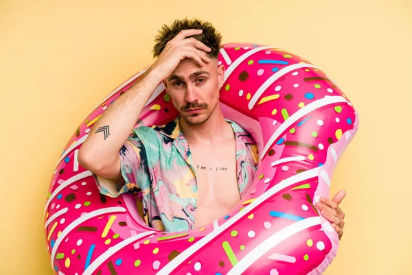 Young Caucasian Man Holding Inflatable Donut Isolated Yellow Background Being — 图库照片