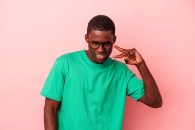 Genç Afrikalı Amerikalı adam pembe arka planda izole edilmiş dans ediyor ve eğleniyor..