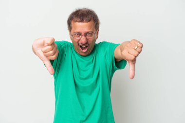 Middle aged indian man isolated on white background showing thumb down and expressing dislike.
