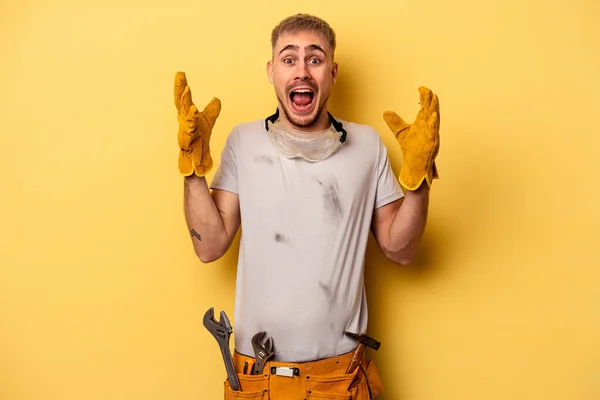 Young Electrician Caucasian Man Isolated Yellow Background Receiving Pleasant Surprise — Zdjęcie stockowe