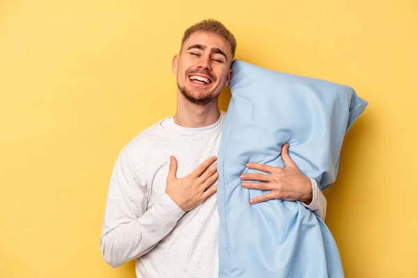 Young Caucasian Man Wearing Pajama Holding Pillow Isolated Yellow Background — ストック写真