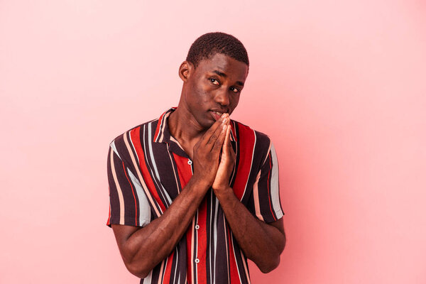 Young African American man isolated on pink background making up plan in mind, setting up an idea.