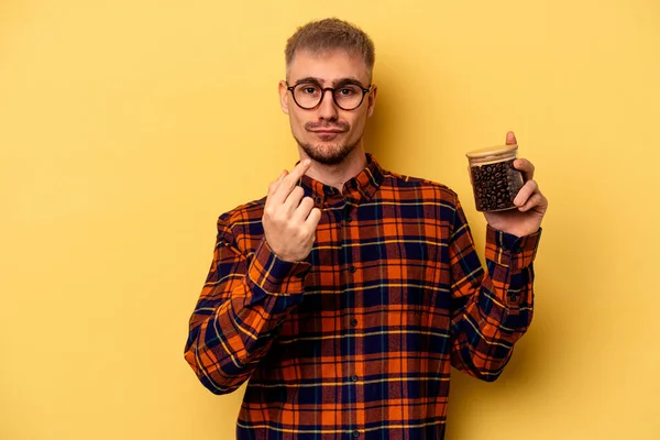 Young Caucasian Man Holding Coffee Jar Isolated Yellow Background Pointing — Stock fotografie